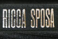 Брендированная лента с печатью логотипа нанесенным вспененой краской для компании Ricca Sposa, цвет ленты - черный (номер ленты 195), цвет краски - серебро, ширина ленты - 10 мм, город Чернигов.