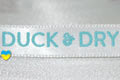 Брендированная лента с печатью логотипа нанесенным вспененой краской для компании Duck Dry, цвет ленты - белый (номер ленты 001), цвет краски - бирюза (как цвет ленты №122), ширина ленты - 10 мм, город Лондон.