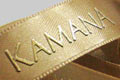 Фирменная лента с печатью вспененой краской Kamana, цвет и номер ленты - К859, цвет краски - золото, ширина ленты - 15 мм.